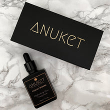 Load image into Gallery viewer, Hydrating hair fragrance bottle and black Anuket box displayed on a white marble background