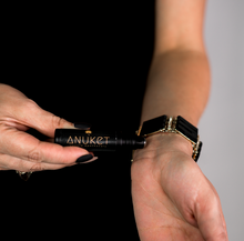 Charger l'image dans la galerie, Woman holding Pure Sakkara Roll-On Fragrance bottle in her hand towards her wrist