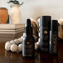 Load image into Gallery viewer, Pure Mimose Diffusing Oil bottle, box and Pure Mimose roll-on fragrance displayed with a background with white wooden beads books and vases