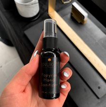 Load image into Gallery viewer, Papyrus Hand Sanitizer bottle being held in a hand