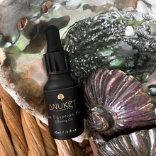 Load image into Gallery viewer, Pure Egyptian Musk Diffusing Oil bottle displayed on a mother pearl with purple and green tones background