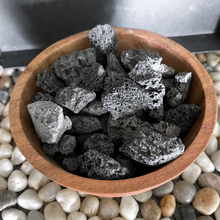 Load image into Gallery viewer, Acacia wood diffusing bowl with black lava stone on a stone background
