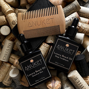 Sandal Wood beard comb, luxury beard oil sensitive skin bottle and Luxury beard oil deep conditioning bottle displayed on a cork background