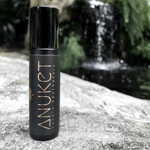 Charger l&#39;image dans la galerie, Pure Egyptian Musk Roll-On Fragrance bottle placed on a stone with a waterfall background