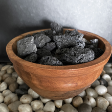 Load image into Gallery viewer, Acacia wood diffusing bowl with black lava stone on a stone background