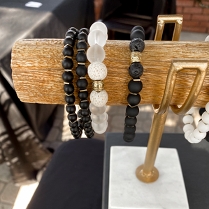 wooden log bracelet holder displaying THE ANUKET Fragrance Diffusing Bracelet